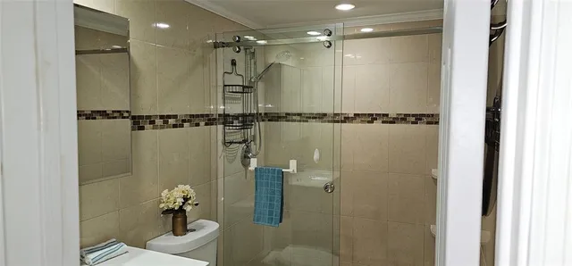 a bathroom with a toilet a sink and a shower