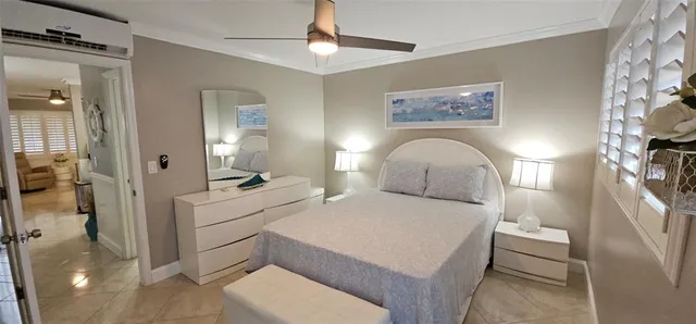 a spacious bedroom with a bed and a chandelier