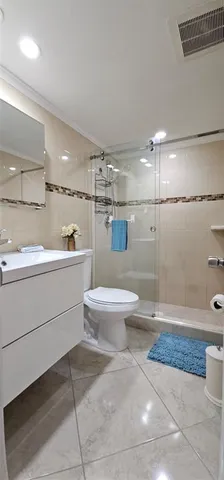 a bathroom with a shower and a toilet