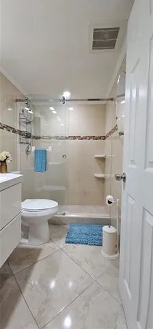 a kitchen with stainless steel appliances granite countertop white cabinets and refrigerator