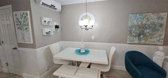 a living room with stainless steel appliances furniture and a kitchen