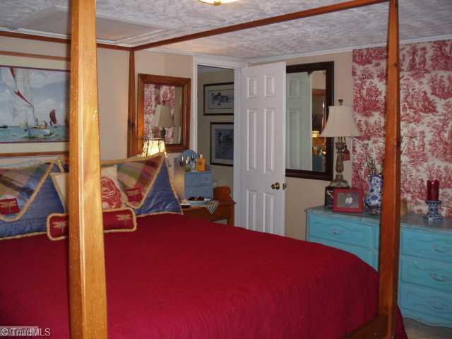 1940 Riverview Road Lexington, NC 27292 - Photo 7 of 13 Master Bedroom. Master bedroom opens to bath and through to closet. Bed faces large picture window viewing the lake.