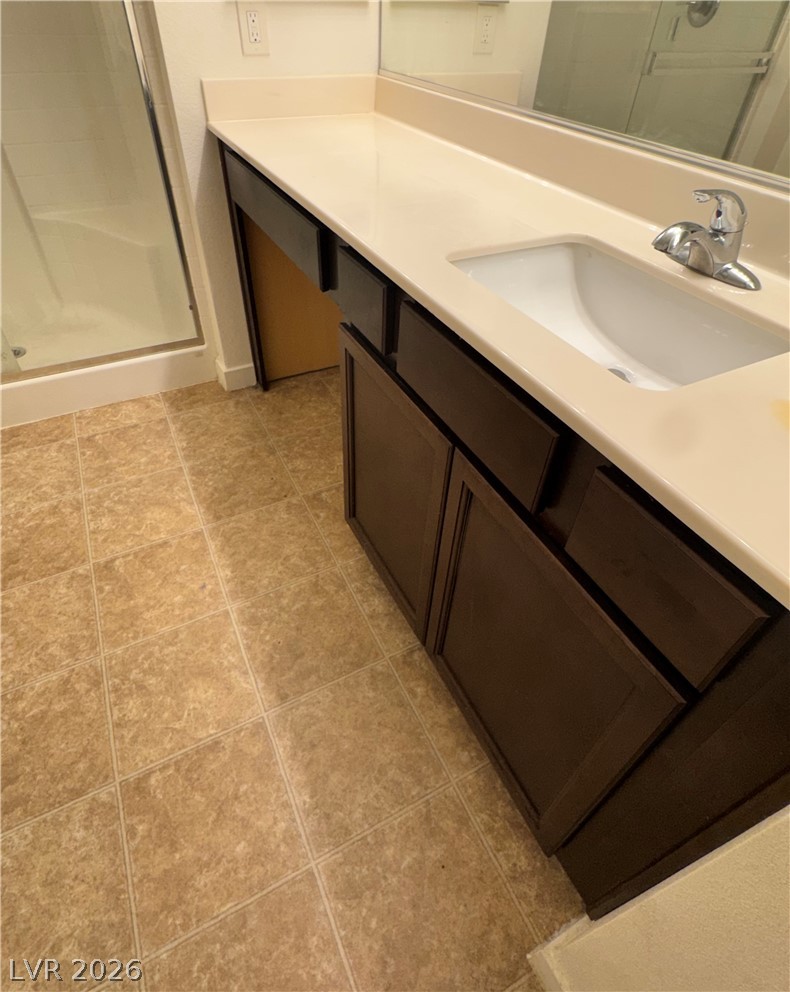 1892 Via Del Rey Court Las Vegas, NV 89115 - Photo 7 of 10 Well-lit vanity area with a crisp white countertop and warm tiled flooring.