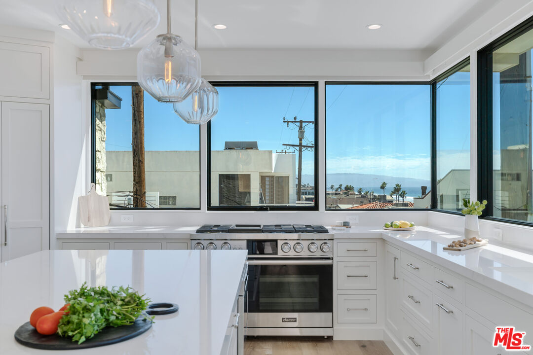 4314 Ocean Drive Manhattan Beach, CA 90266 - Photo 13 of 46 a kitchen with stainless steel appliances granite countertop a stove a sink and a microwave
