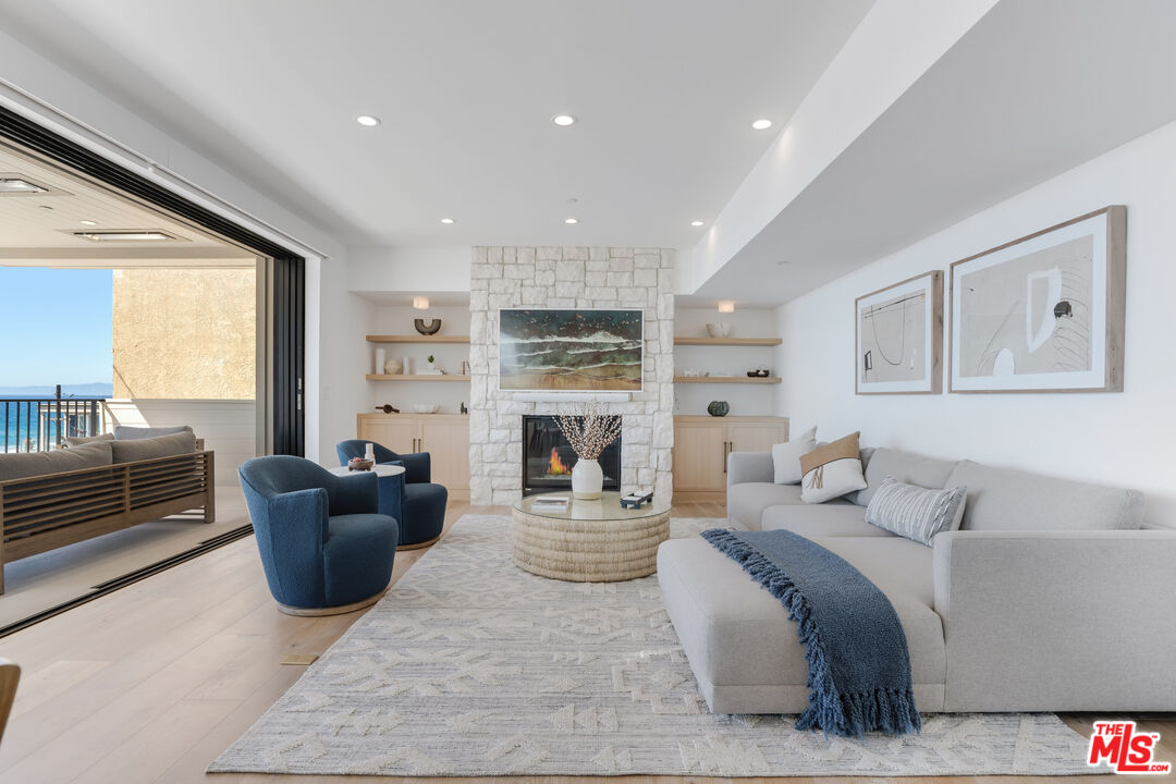 4314 Ocean Drive Manhattan Beach, CA 90266 - Photo 16 of 46 a living room with fireplace furniture and a large window