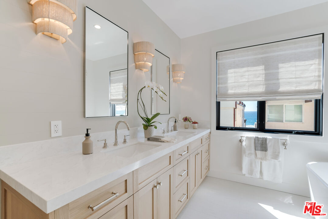 4314 Ocean Drive Manhattan Beach, CA 90266 - Photo 23 of 46 a bathroom with a double vanity sink mirror and