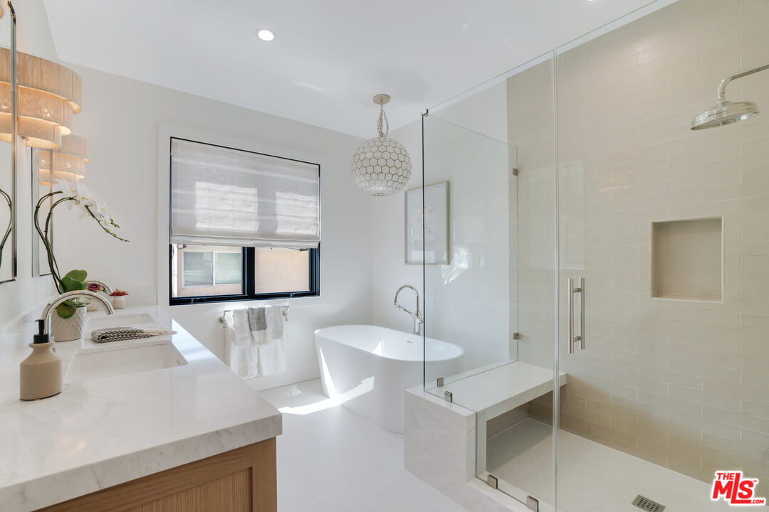 4314 Ocean Drive Manhattan Beach, CA 90266 - Photo 24 of 46 a bathroom with a sink a mirror and a shower