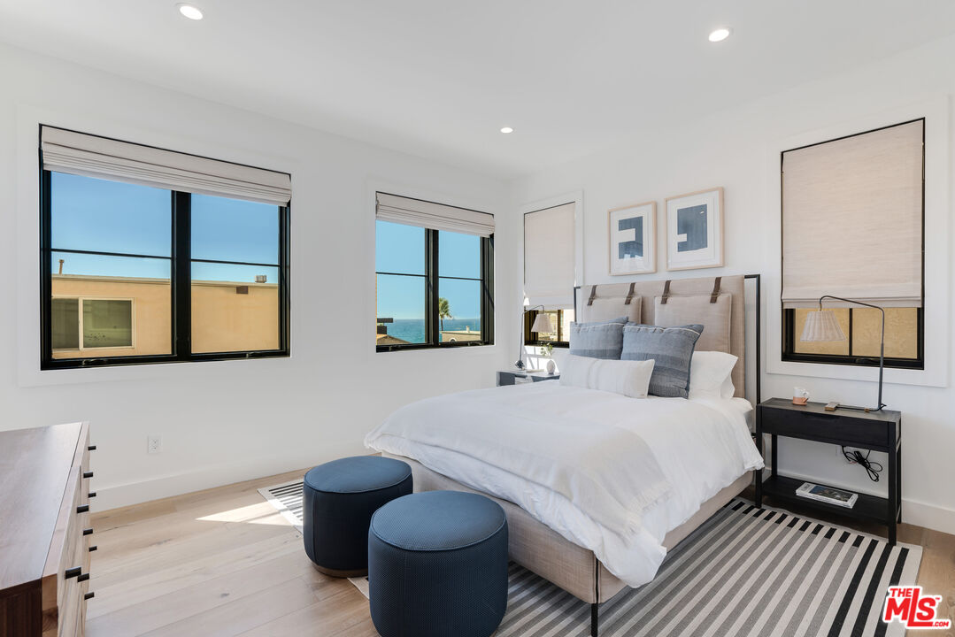 4314 Ocean Drive Manhattan Beach, CA 90266 - Photo 32 of 46 a bedroom with a bed and wooden floor