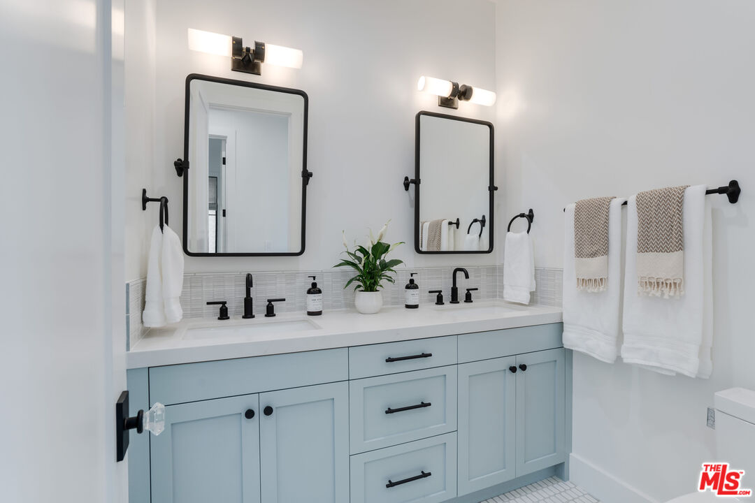 4314 Ocean Drive Manhattan Beach, CA 90266 - Photo 36 of 46 a bathroom with double vanity sinks and a mirror