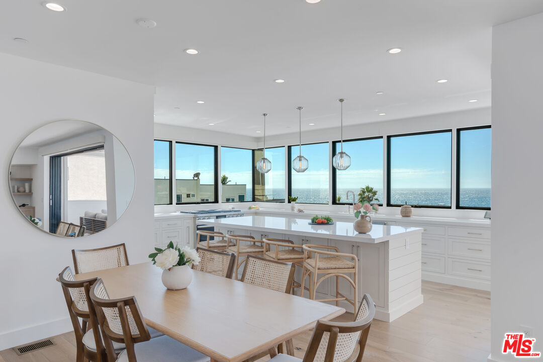 4314 Ocean Drive Manhattan Beach, CA 90266 - Photo 6 of 46 a dining room with stainless steel appliances furniture a large window and a kitchen view