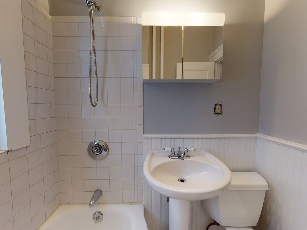 59 Lanark Road, Unit 4 Boston, MA 02135 - Photo 13 of 25 a bathroom with a sink and mirror