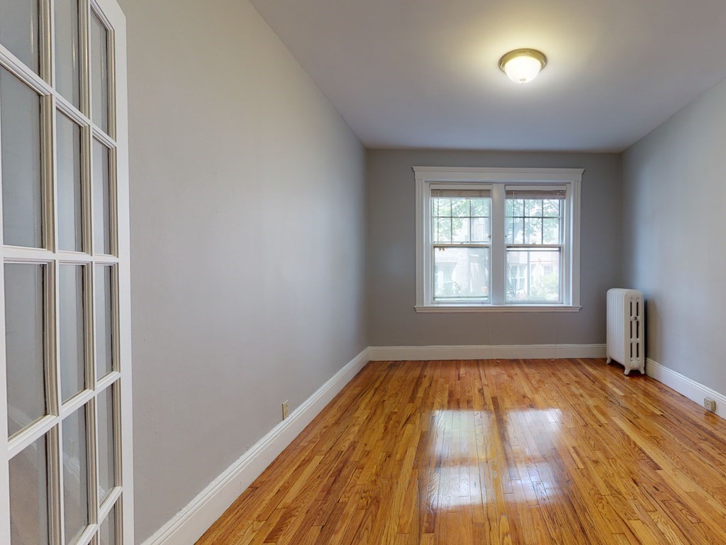 59 Lanark Road, Unit 4 Boston, MA 02135 - Photo 18 of 25 a view of empty room with wooden floor and fan