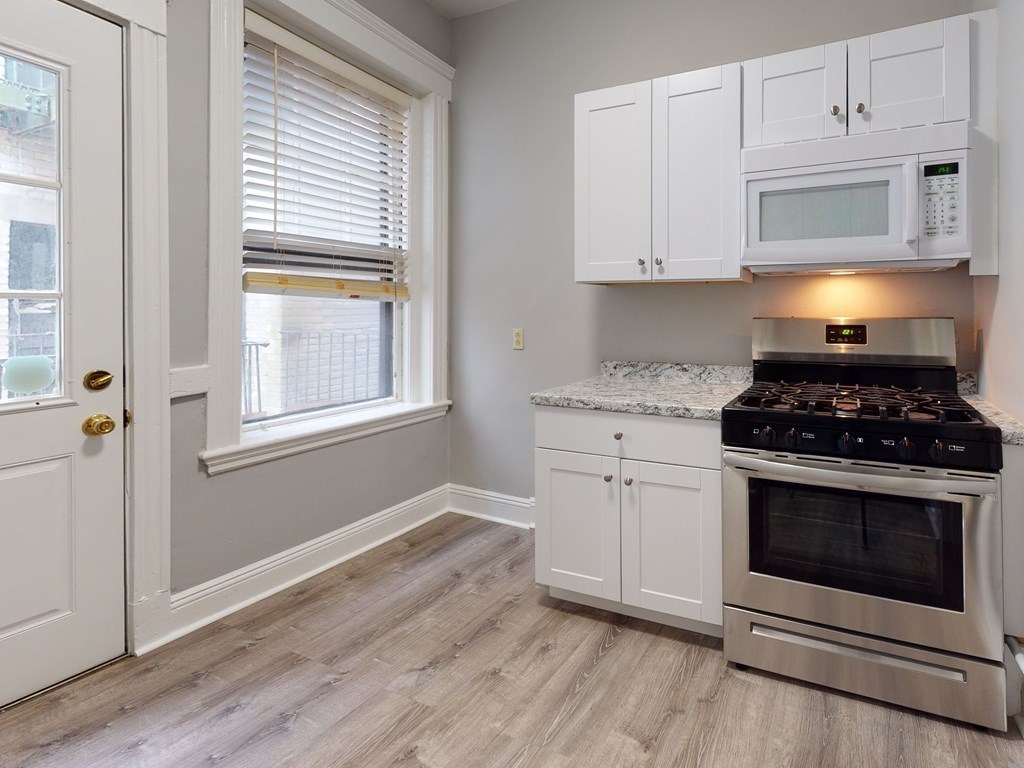 59 Lanark Road, Unit 4 Boston, MA 02135 - Photo 6 of 25 a kitchen with cabinets appliances and a window