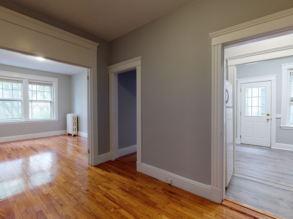 59 Lanark Road, Unit 4 Boston, MA 02135 - Photo 8 of 25 an empty room with wooden floor and windows
