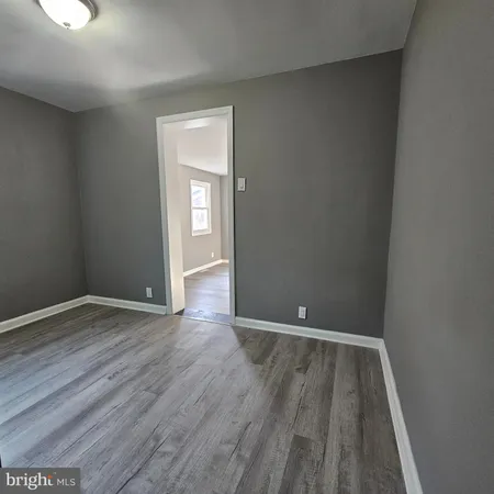 a view of room with window and wooden floor
