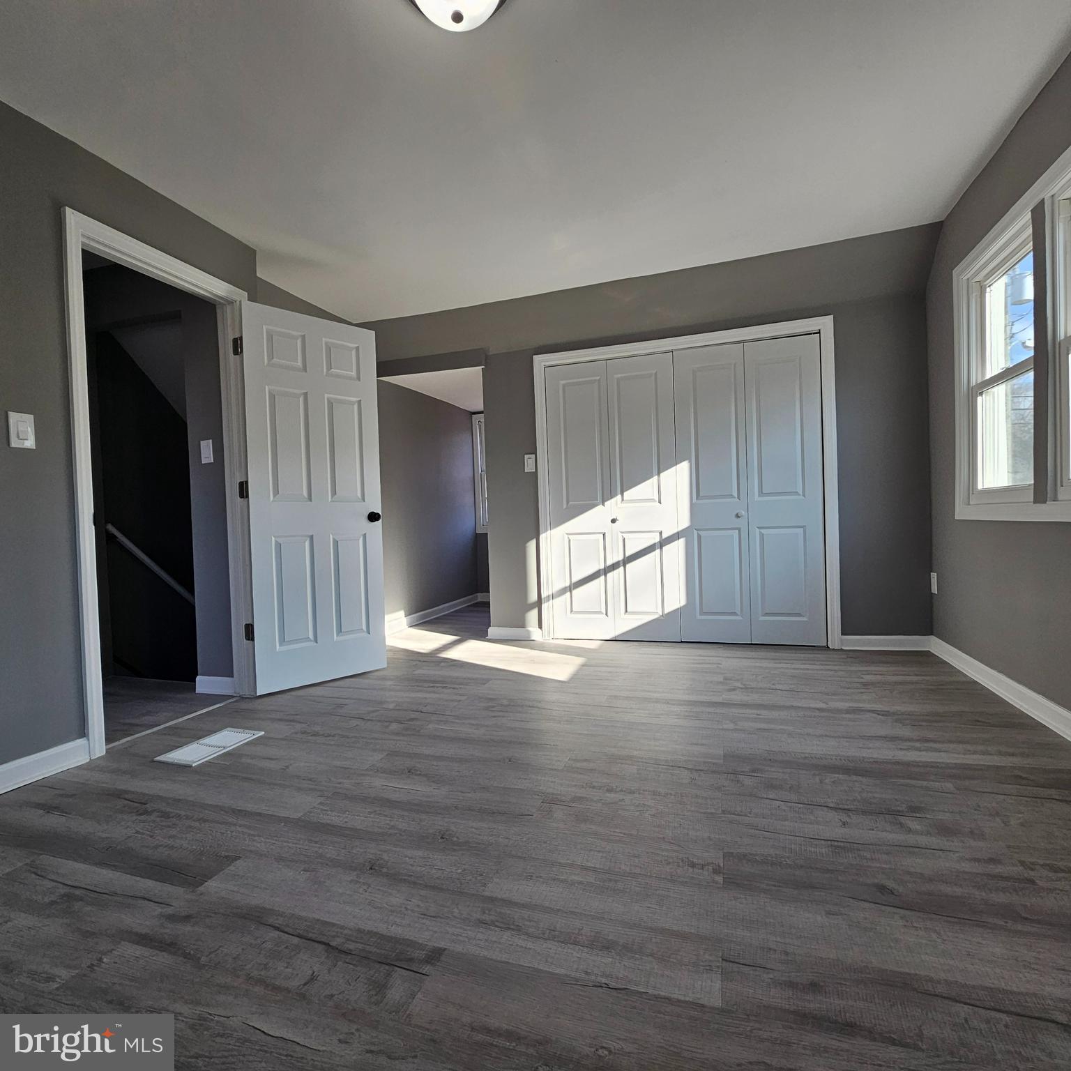 41 Churchtown Road Pennsville, NJ 08070 - Photo 15 of 16 an empty room with wooden floor and windows