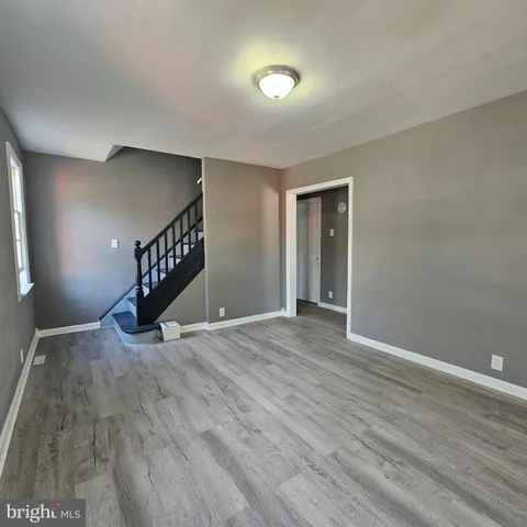 a view of an empty room and wooden floor
