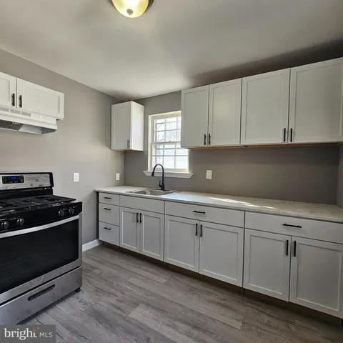 a kitchen with granite countertop white cabinets and white appliances