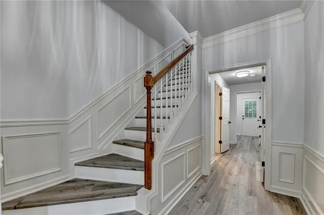 a view of entryway and hall with wooden floor