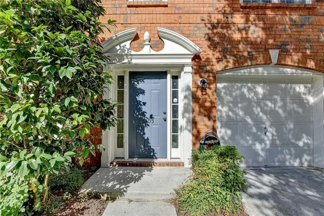 a view of a brick house with a tree