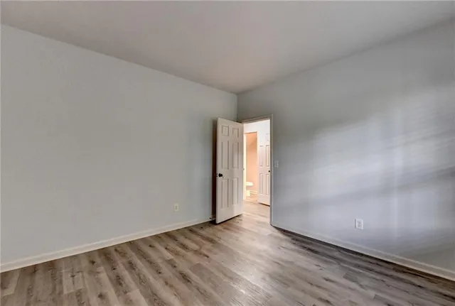 a view of an empty room and wooden floor