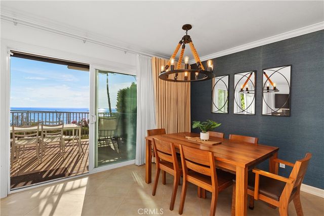 a dining room with furniture a chandelier and wooden floor