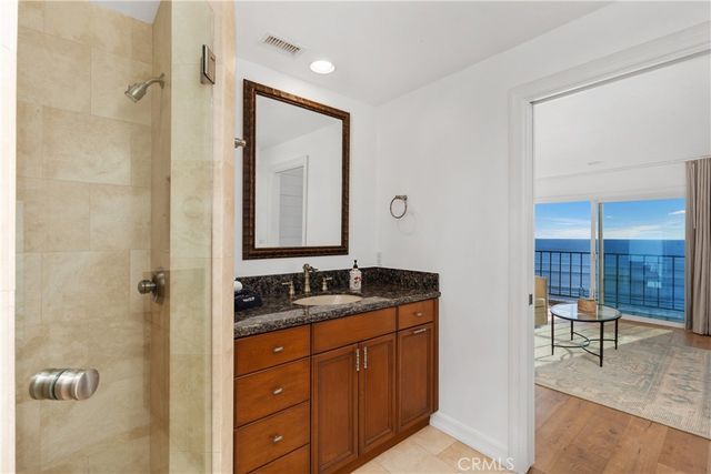 a bathroom with a granite countertop sink and a mirror
