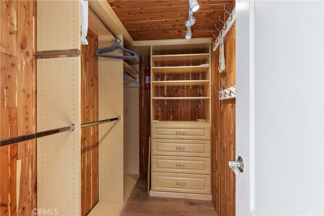 a view of walk in closet with empty racks