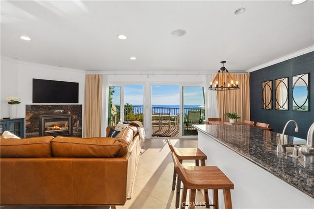 a living room with fireplace furniture and a flat screen tv