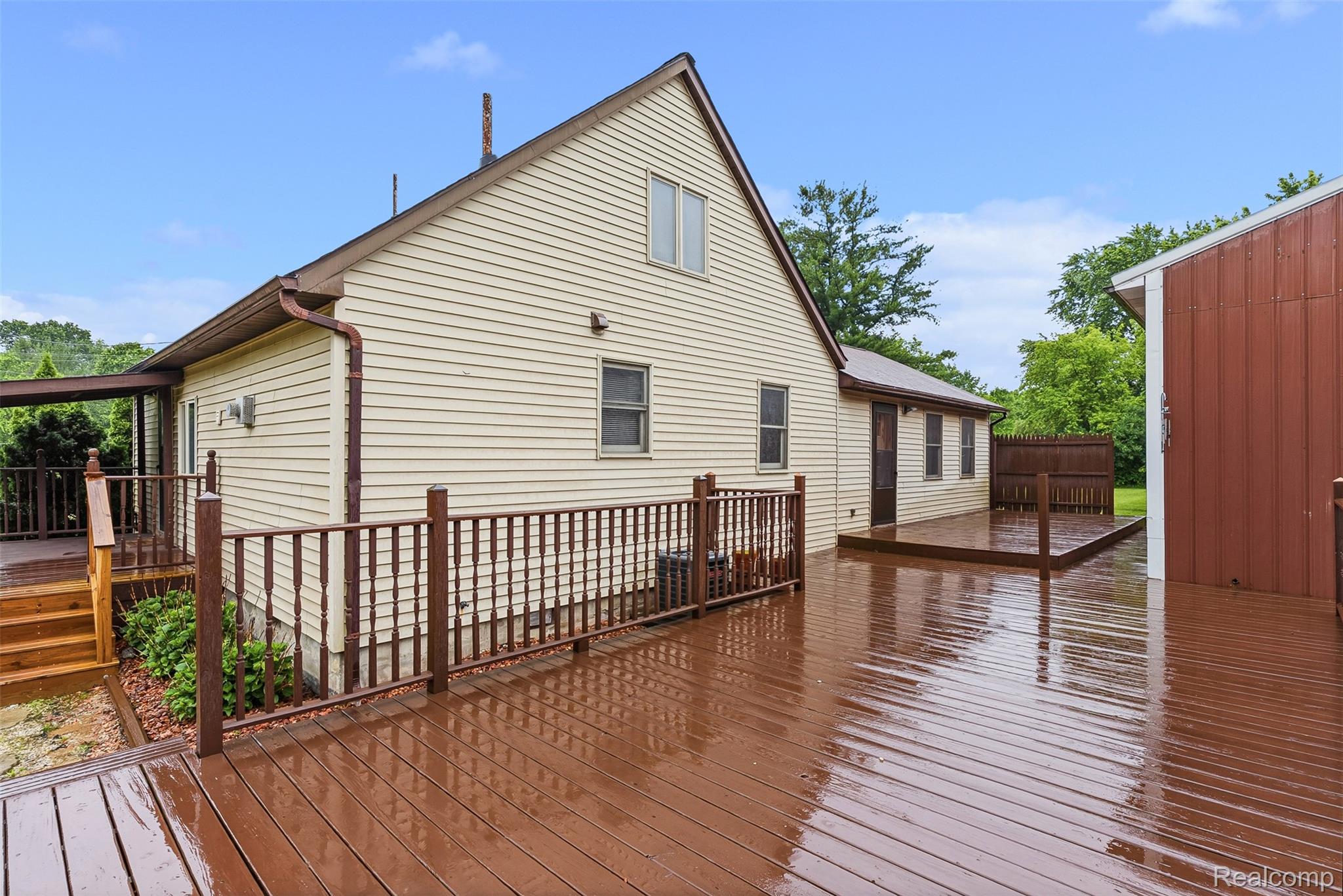 6109 North State Road Davison, MI 48423 - Photo 36 of 39 Multi-level wood-finish deck with full railings, providing extensive outdoor living space