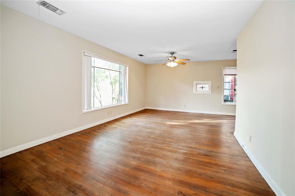 2905 Robinson Avenue, Unit A Austin, TX 78722 - Photo 2 of 9 an empty room with wooden floor and windows