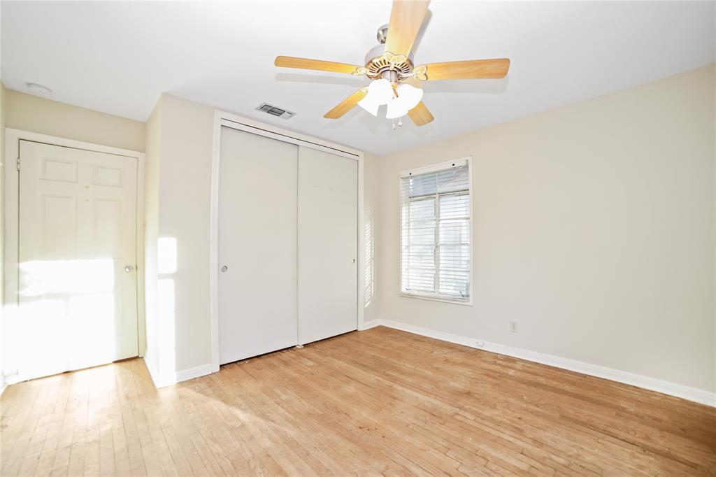 2905 Robinson Avenue, Unit A Austin, TX 78722 - Photo 6 of 9 an empty room with wooden floor fan and windows