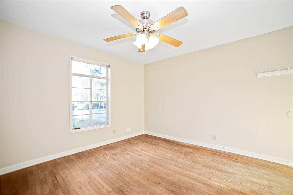 2905 Robinson Avenue, Unit A Austin, TX 78722 - Photo 7 of 9 an empty room with windows and fan