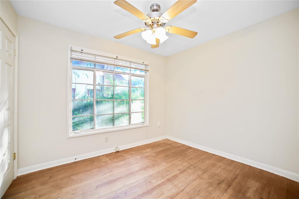 2905 Robinson Avenue, Unit A Austin, TX 78722 - Photo 8 of 9 an empty room with a window and a fan