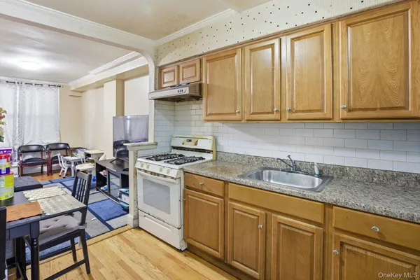 a kitchen with a stove a sink and cabinets