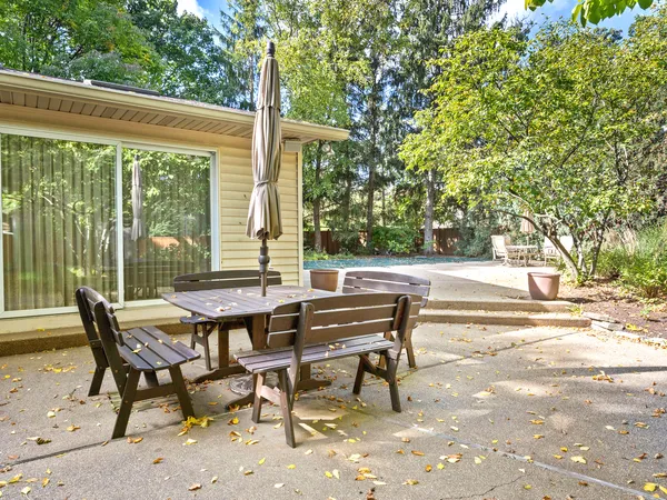 a view of a patio with a table and chairs and couches