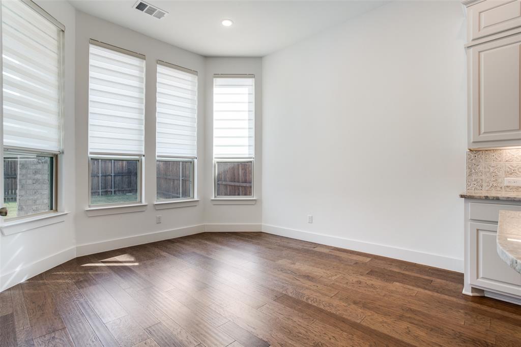 717 Corner Post Path Celina, TX 75009 - Photo 6 of 12 an empty room with wooden floor and windows