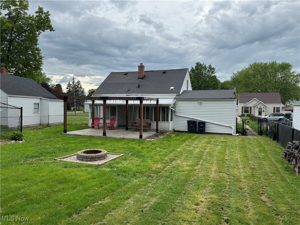 1139 Kessel Avenue Akron, OH 44310 - Photo 31 of 36 Rear view of property with a fire pit, a patio, a chimney, and roof with shingles