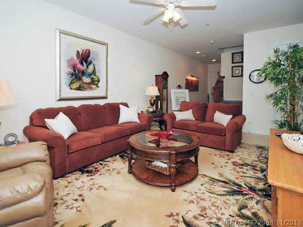 134 Southwest Walking Path Stuart, FL 34997 - Photo 11 of 25 Living Room. Tile Flooring, Ceiling Fans, Neutral Decor
