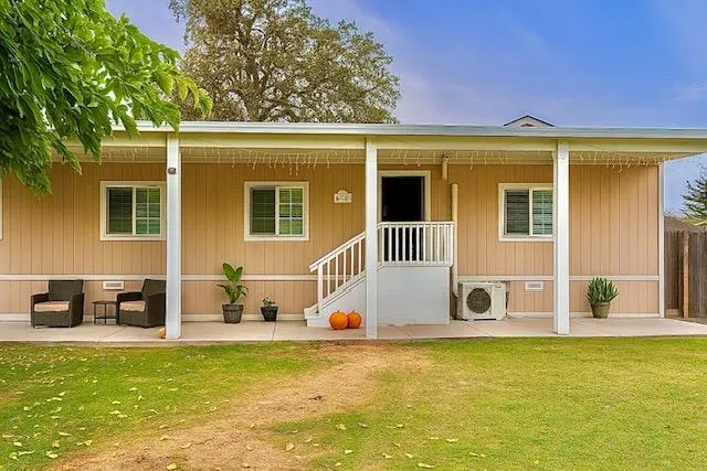 a view of a house with a swimming pool and sitting area