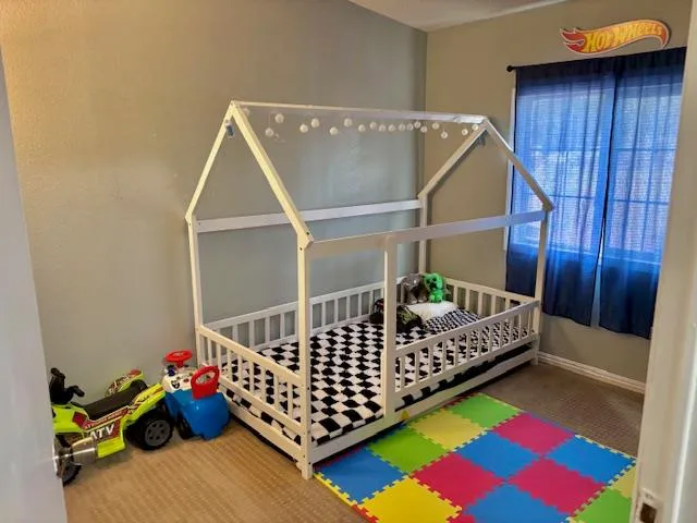 a bedroom with baby crib and furniture