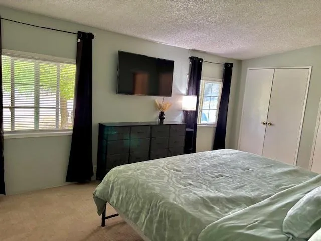 a bedroom with a bed and a flat screen tv