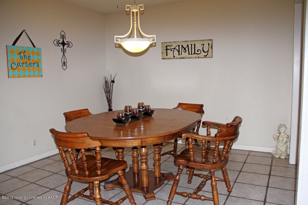 7208 Jameson Road Amarillo, TX 79106 - Photo 11 of 40 a view of a dining room with furniture and chandelier