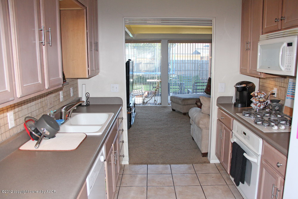 7208 Jameson Road Amarillo, TX 79106 - Photo 15 of 40 a kitchen with sink cabinets and stove