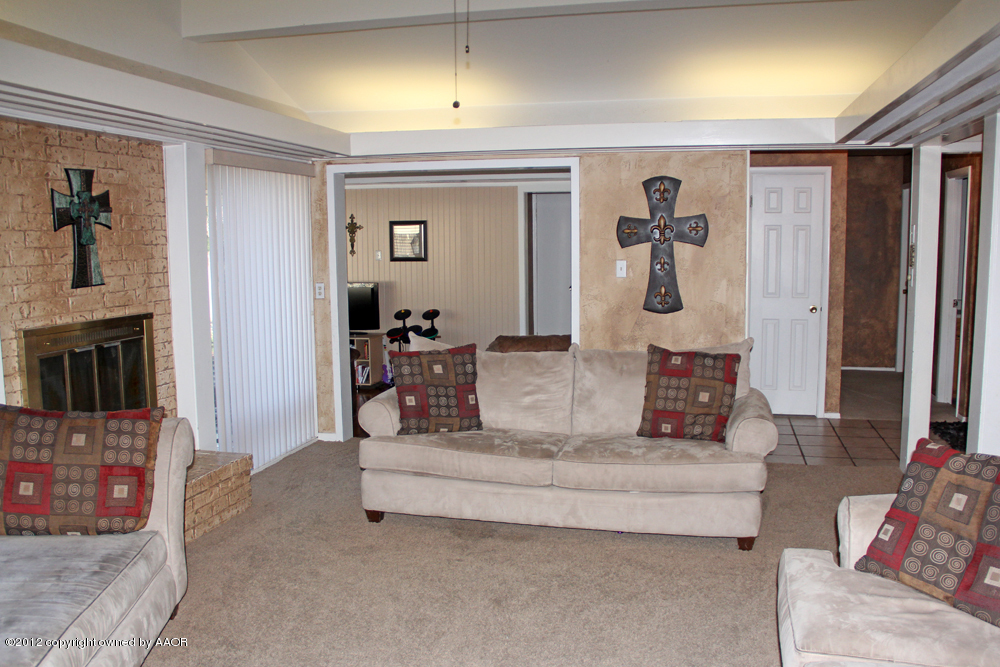 7208 Jameson Road Amarillo, TX 79106 - Photo 7 of 40 a living room with furniture and a fireplace
