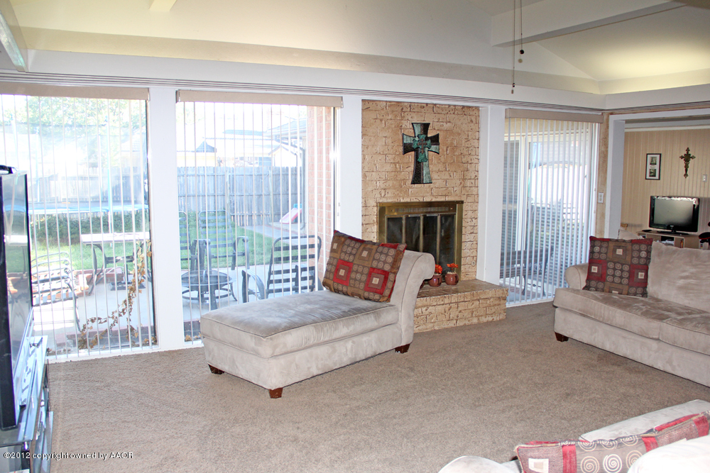7208 Jameson Road Amarillo, TX 79106 - Photo 8 of 40 a living room with furniture and a fireplace