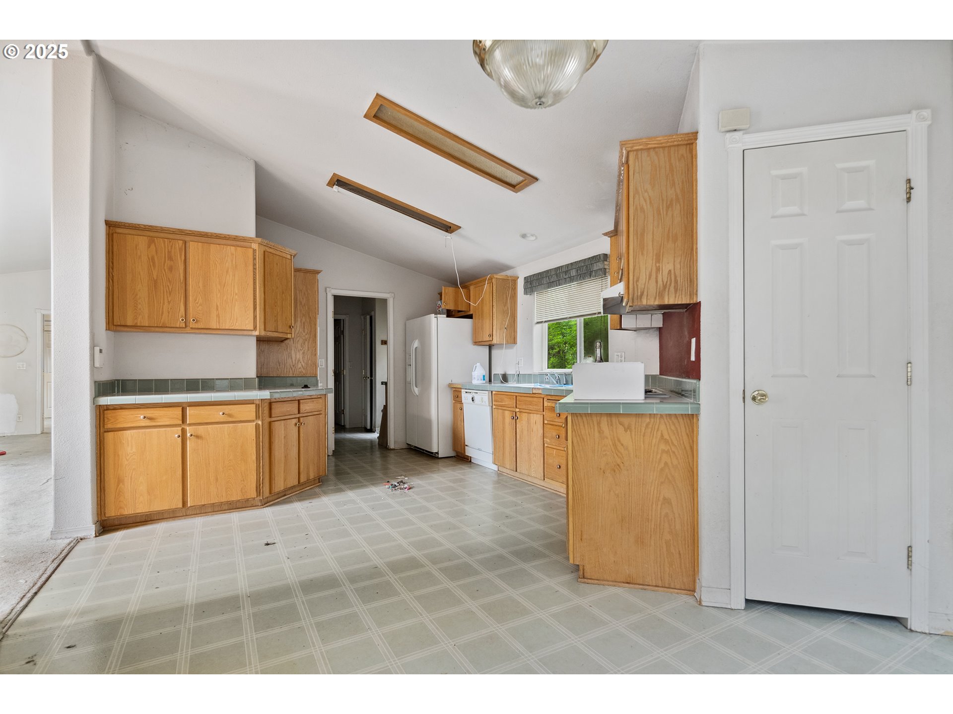 25482 East Cedar Glen Loop Welches, OR 97067 - Photo 11 of 20 a kitchen with stainless steel appliances kitchen island granite countertop a refrigerator and a sink