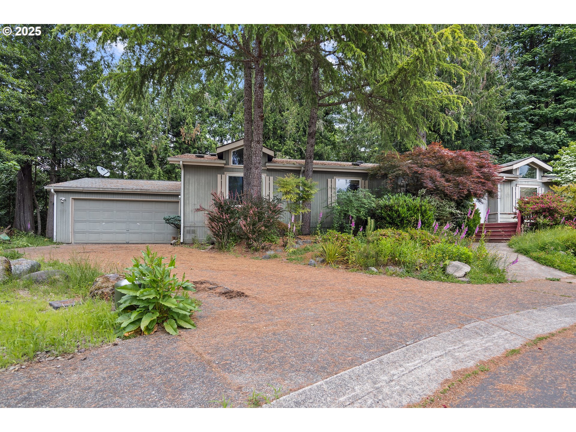 25482 East Cedar Glen Loop Welches, OR 97067 - Photo 2 of 20 a front view of a house with a yard and a garage