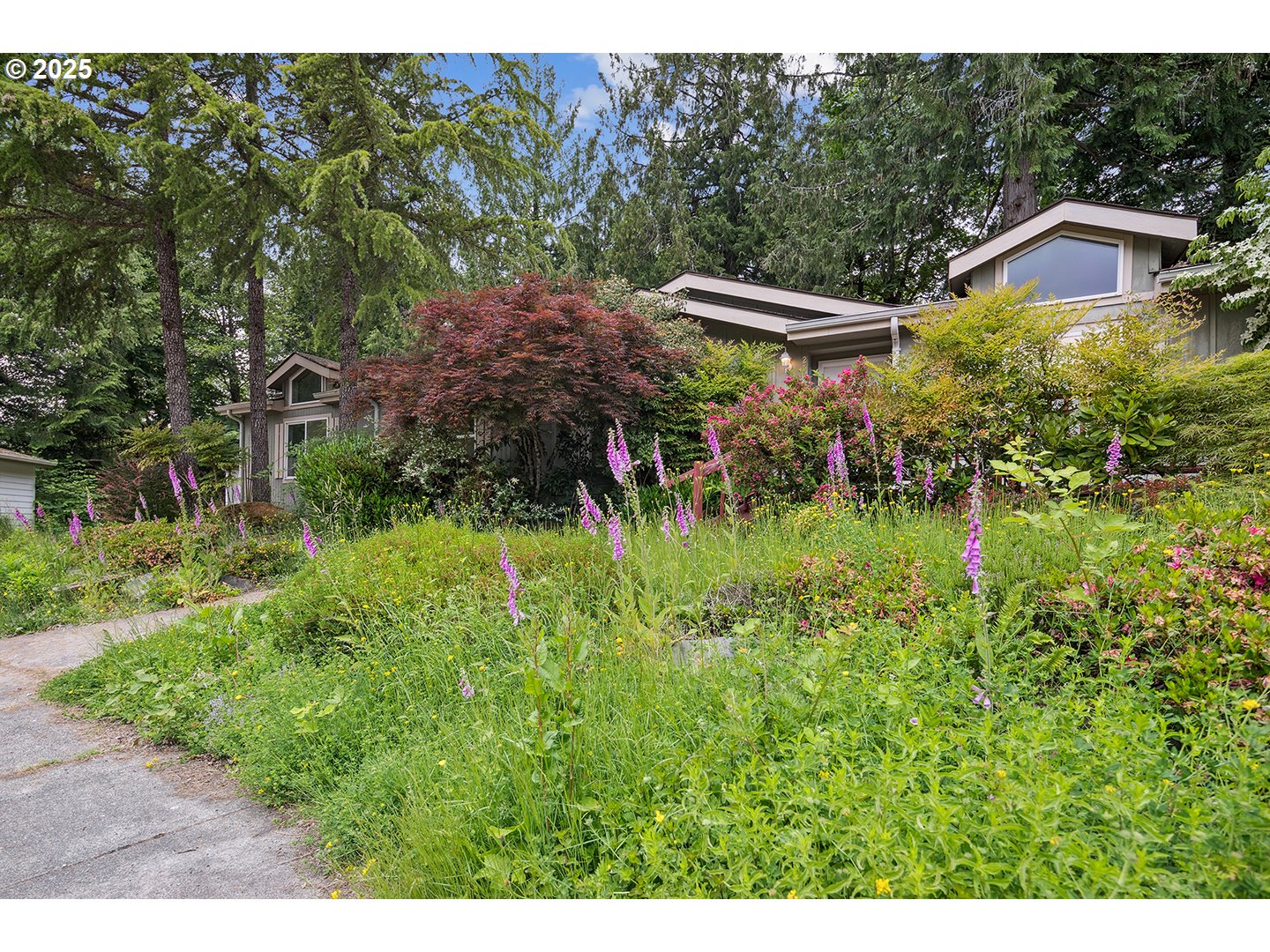 25482 East Cedar Glen Loop Welches, OR 97067 - Photo 3 of 20 a view of a garden with a bench