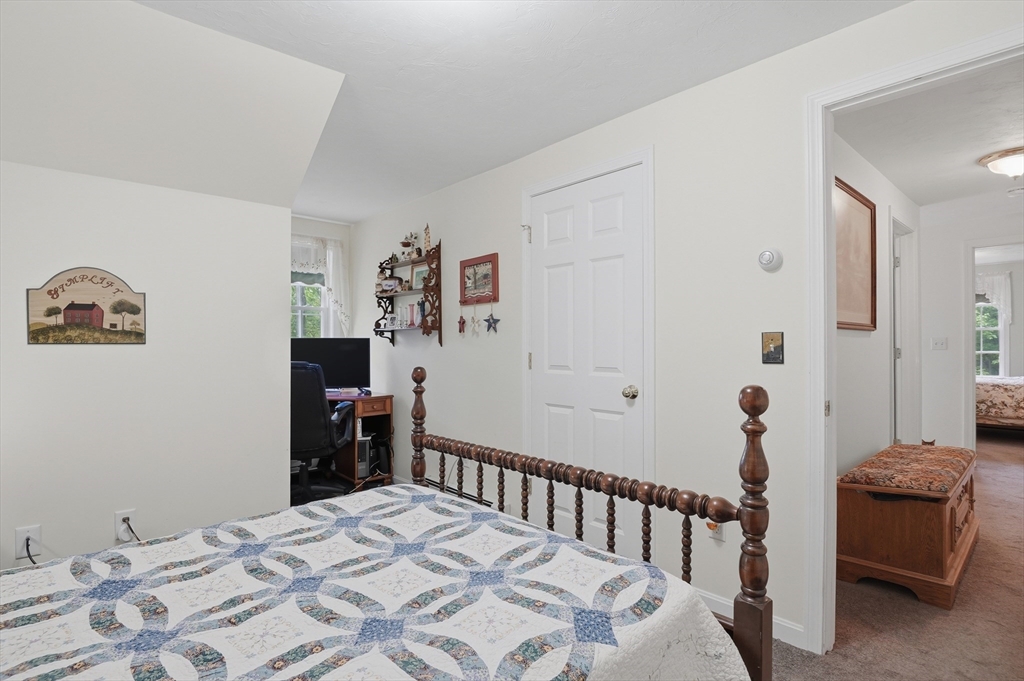 186 Common Street Groton, MA 01450 - Photo 24 of 28 a bedroom with a bed and a table in it